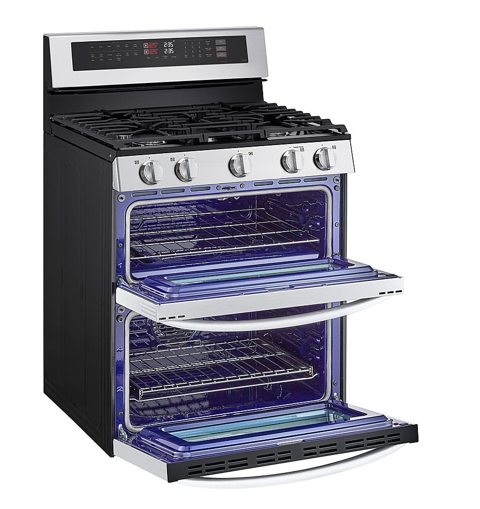 The image features a large black and silver oven with a blue interior. The oven has a stove top and an open door, revealing the blue interior. The oven is equipped with a timer and a digital display, making it a modern and functional appliance. The oven's size and features make it suitable for cooking various dishes and catering to the needs of a household or a restaurant.