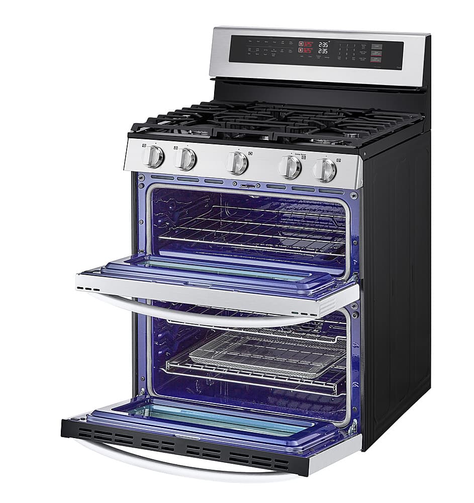 The image features a large stainless steel oven with a blue interior. The oven has a stove top and a double oven, making it a versatile appliance for cooking and baking. The oven is open, revealing the blue interior and the various racks inside. The oven is a modern and stylish addition to any kitchen.