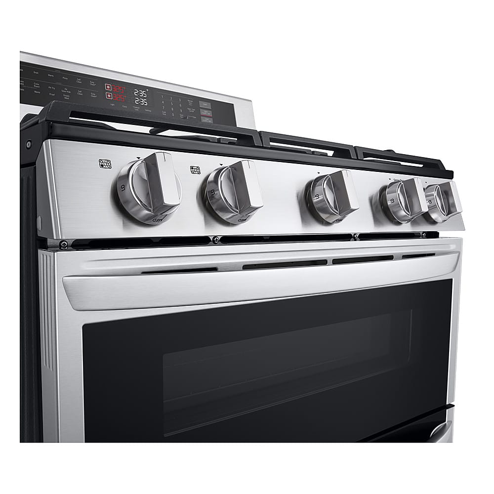 The image features a stainless steel oven with a black door, sitting on top of a black counter. The oven has a digital display and a timer, which shows the time of 2:35. The oven has a total of six knobs, indicating that it is a six-burner stove. The oven is likely a modern and high-quality appliance, suitable for various cooking needs.