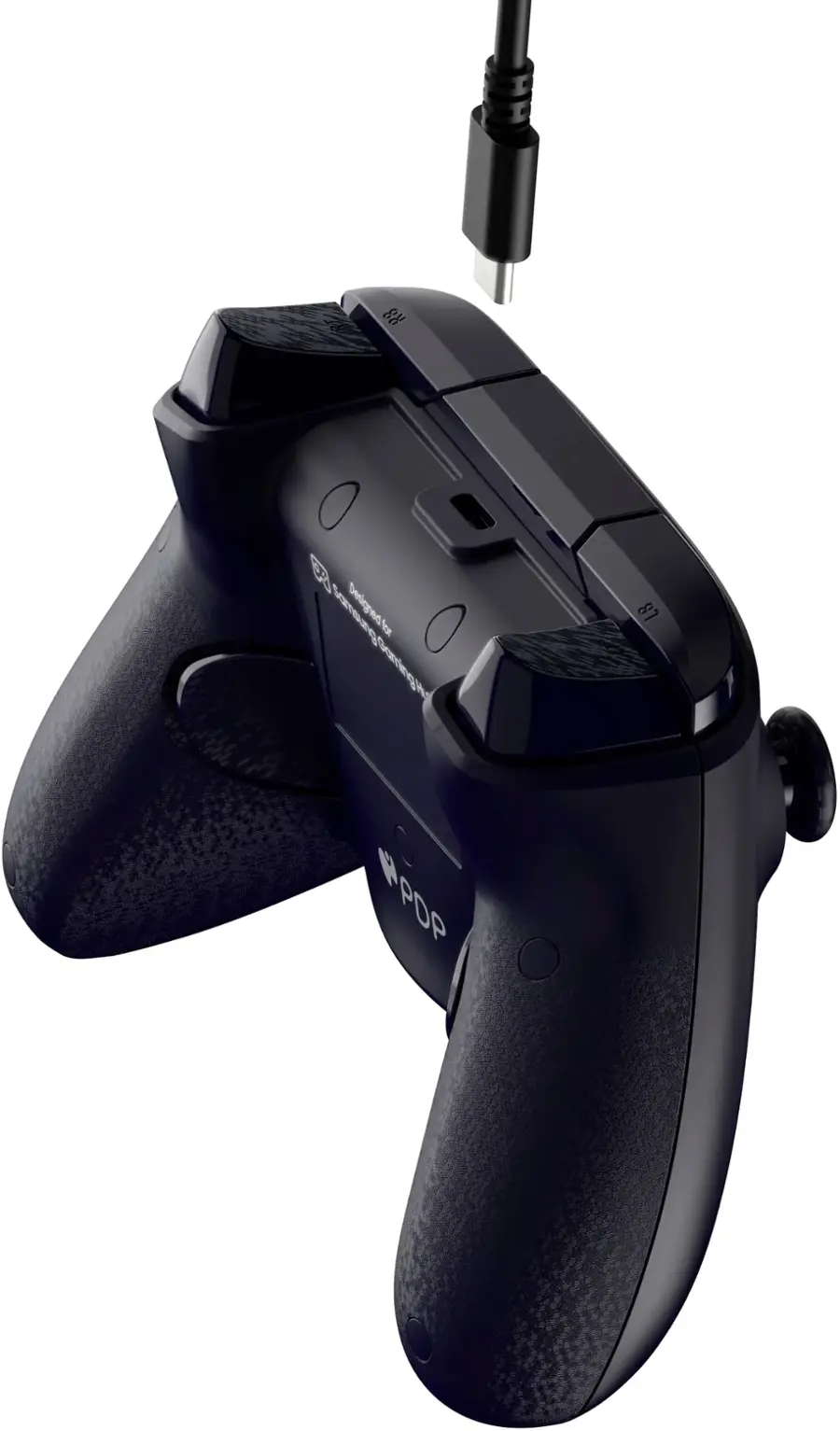 The image features a black and grey PlayStation 3 controller, which is designed by PDP. The controller is hanging on a white background, and it appears to be a close-up shot. The controller has a cord attached to it, which is likely used for charging or connecting to a gaming console.
