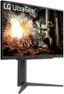 The image features a large LG UltraGear monitor, which is prominently displayed in the scene. The monitor is placed on a stand and is surrounded by various objects, such as a statue, a chair, and a fireplace. The overall setting appears to be a room with a cozy and comfortable atmosphere.