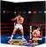 The image features a statue of Rocky Balboa, a famous boxer, standing in a boxing ring. The statue is wearing a white and red uniform, and it is holding boxing gloves. The statue is displayed on a blue surface, which could be a boxing ring or a display stand. The statue is positioned in a way that it appears to be posing for a picture, capturing the essence of the iconic boxer.