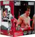 The image features a box of Rocky Balboa Movie Maniacs action figures, which includes a figure of Rocky himself. The box is red and white, and it is placed on a white background. The Rocky figure is prominently displayed on the box, showcasing his iconic pose. The box also includes a limited edition autographed card, adding value to the collectible. The Rocky Balboa Movie Maniacs action figures are produced by MGM and are part of a collectible series.