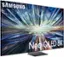 The image features a large Samsung Neo QLED 8K television screen. The TV screen is displaying a colorful, dynamic scene with bright colors and light streaks. The screen is placed on a stand, and the TV is prominently displayed in the image.