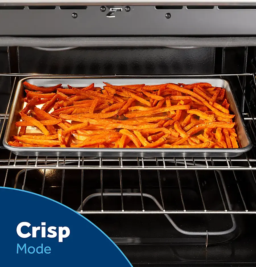 The image features a large oven with a tray of food inside, specifically a pan of fries. The oven is set to "Crisp Mode," which is a cooking setting designed to achieve a crispy texture on the food. The oven is open, allowing us to see the food inside, and the fries appear to be cooked to perfection.