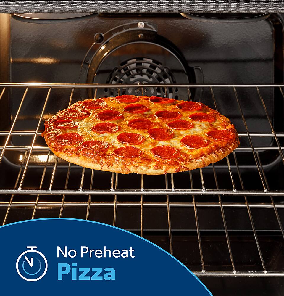 The image shows a pepperoni pizza sitting in a black oven, which is turned off. The pizza is placed on a rack, and there is no preheat required for this pizza. The oven is empty, and the pizza is ready to be cooked.
