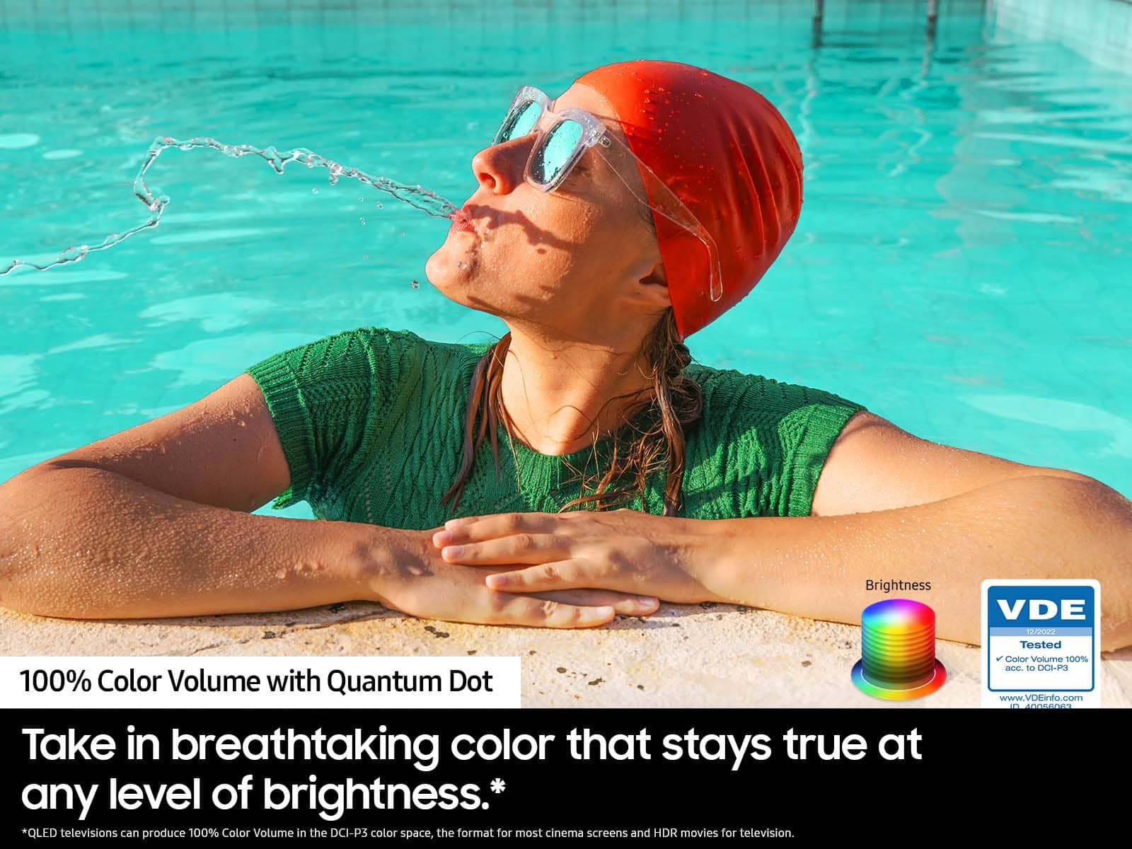 The image features a woman wearing a red swim cap and goggles, laying on her back in a pool of water. She appears to be enjoying her time in the water, possibly swimming or relaxing. The image is being used to advertise a product, likely related to swimming or water sports, as it is described as a "swimming advertisement." The advertisement claims to offer "100% Color Volume with Quantum Dot," which suggests that the product may be a high-quality, colorful swimwear or swimming accessory.