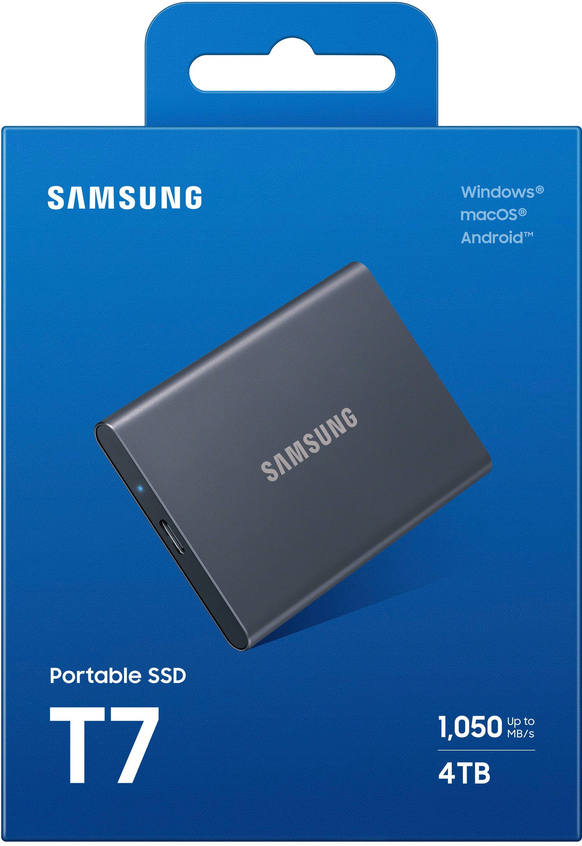 The image features a Samsung Portable SSD T7, which is a 4TB external hard drive. The hard drive is still in its original packaging, with the blue box surrounding it. The packaging provides information about the product, such as its compatibility with Windows, Mac, and Android systems. The Samsung Portable SSD T7 is designed for fast data transfer speeds, reaching up to 1,050 MB/s.