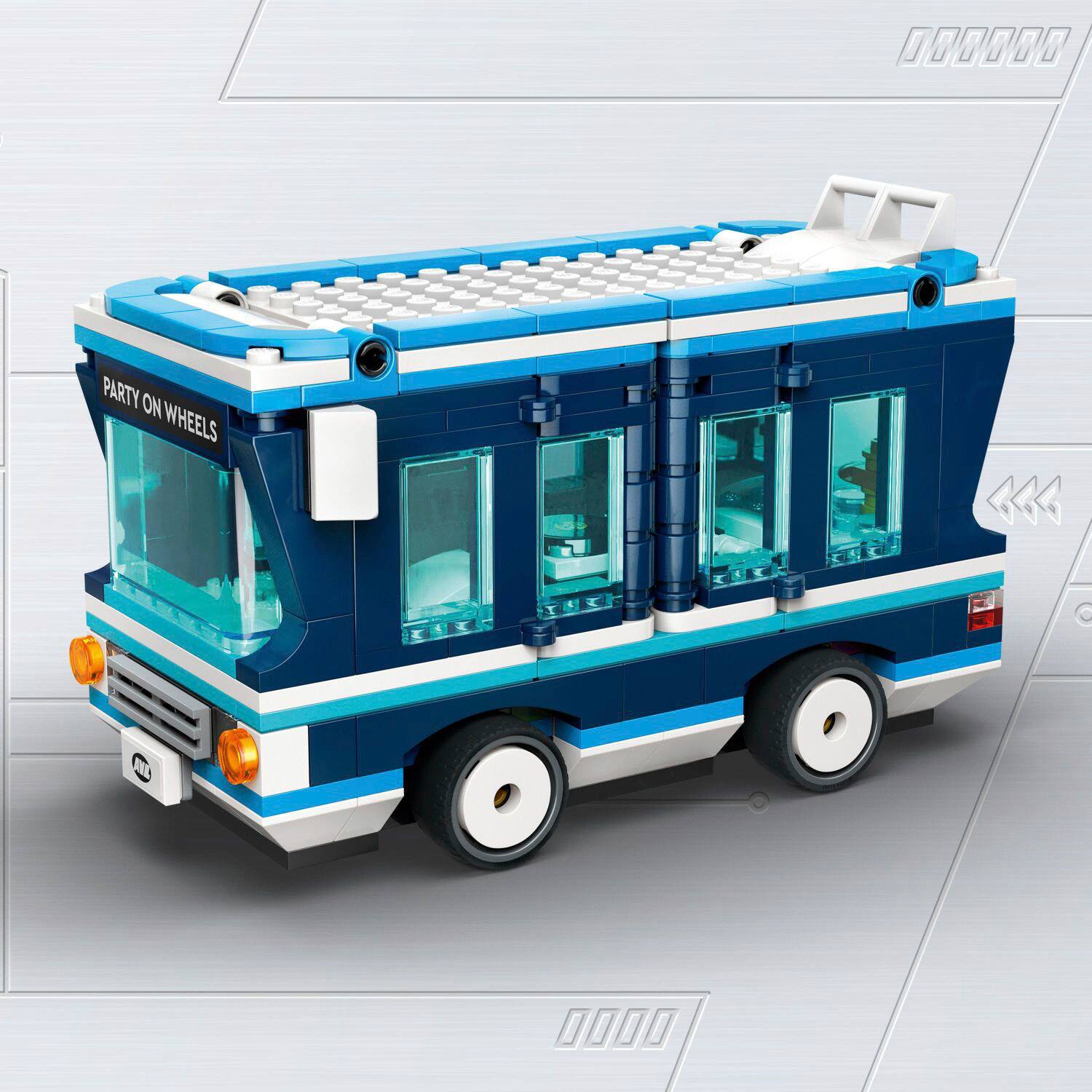 The image features a small blue and white bus, possibly a toy or a model, with the words "Party on Wheels" written on the front. The bus is parked on a white surface, and it appears to be a fun and unique vehicle for transportation or entertainment.
