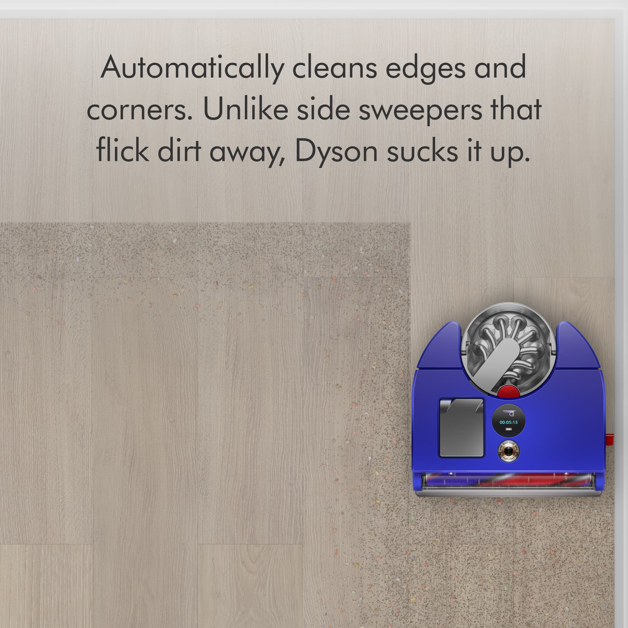 The image features a blue vacuum cleaner that is designed to clean edges and corners. Unlike traditional side sweepers that flick dirt away, Dyson sucks it up. This vacuum cleaner is specifically designed to handle hard-to-reach areas and provide efficient cleaning.
