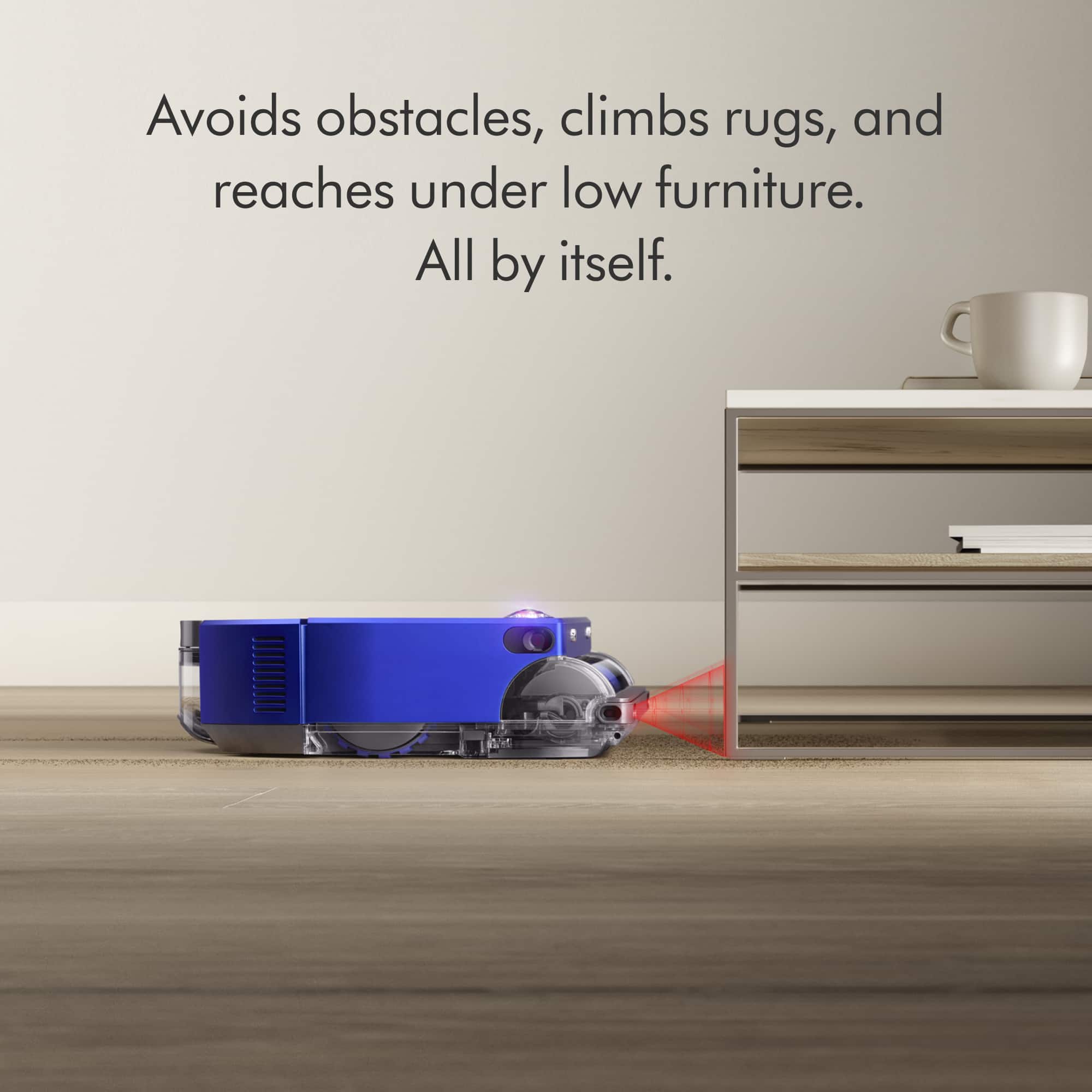 The image shows a blue robotic vacuum cleaner on a wooden floor, with a coffee table and a cup nearby. The vacuum cleaner is designed to avoid obstacles, climb rugs, and reach under low furniture, making it a convenient and efficient cleaning tool.