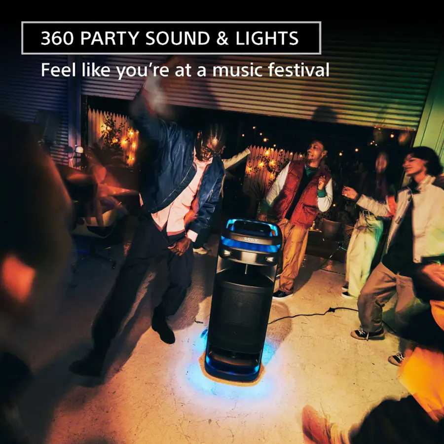 The image depicts a lively scene with a group of people dancing and enjoying themselves. There are at least six people in the scene, with some of them standing close to each other and others spread out. A man is dancing in front of a speaker, which suggests that the music is playing loudly and creating a festive atmosphere. The people are engaged in various activities, such as dancing, clapping, and singing, contributing to the overall energetic and fun vibe of the scene.