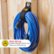 The image features a blue cord hanging on a wall, secured by a hook and loop fastener. The hook and loop fastener is described as "Super-Strong," indicating that it can hold up to 50 lbs (22.6 kg) of weight. The cord appears to be a cable tie or holder, designed to keep cords organized and prevent them from tangling.