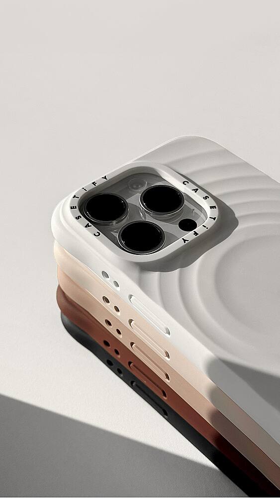 The image features a white and brown cell phone case with a black center. The case is designed to protect the phone from scratches and minor impacts. The case has a unique design with a black center, which adds a touch of style to the device. The case is placed on a white surface, which provides a clean and minimalist background for the image.