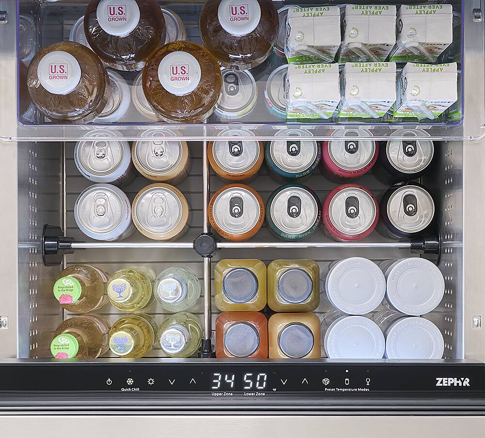 The image shows a refrigerator with a variety of drinks inside. There are several bottles, including juice and soda, placed in different compartments of the refrigerator. The refrigerator also has a clock on the front, which shows the time. The drinks are organized in a way that allows for easy access and visibility. The refrigerator is filled with a wide assortment of beverages, catering to different tastes and preferences.