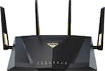 The image features a black and gold router with three antennas on top. The router is made by ASUS and has a unique design. The antennas are positioned at different angles, providing better coverage and signal strength. The router is placed on a white background, which highlights its sleek and modern appearance.