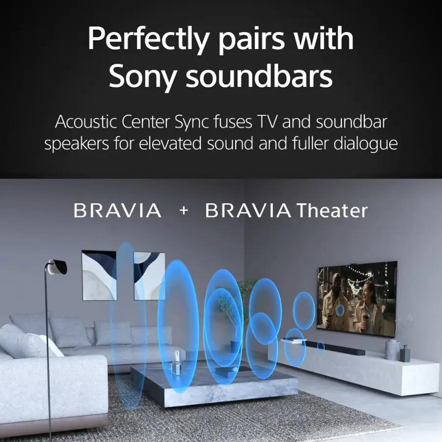 The image showcases a living room with a couch and a flat screen TV. The TV is paired with Sony soundbars, which are designed to enhance the audio experience. The soundbars are placed on a table in front of the TV, creating an immersive entertainment setup. The living room also features a potted plant, adding a touch of greenery to the space. The combination of the TV, soundbars, and comfortable seating creates a cozy and enjoyable environment for watching movies or shows.
