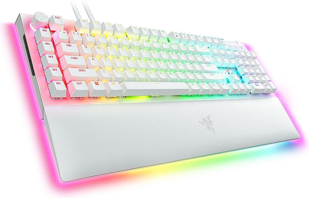 The image features a colorful keyboard with a rainbow-colored design. The keyboard has a white base and is adorned with a variety of colors, including pink, yellow, green, and blue. The keys are arranged in a row, with the letters and numbers visible on the keys. The keyboard is placed on a white surface, and the overall scene is visually appealing and vibrant.