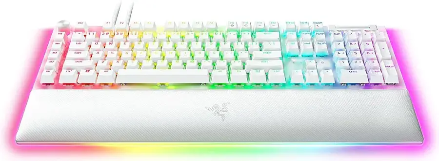 The image features a colorful keyboard with a rainbow theme. The keyboard has a white base and is adorned with a variety of colors, including pink, blue, green, yellow, and orange. The keys are arranged in a standard layout, with the letters and numbers spread across the keyboard. The keyboard is designed to be visually appealing and unique, making it a fun and eye-catching addition to any computer setup.