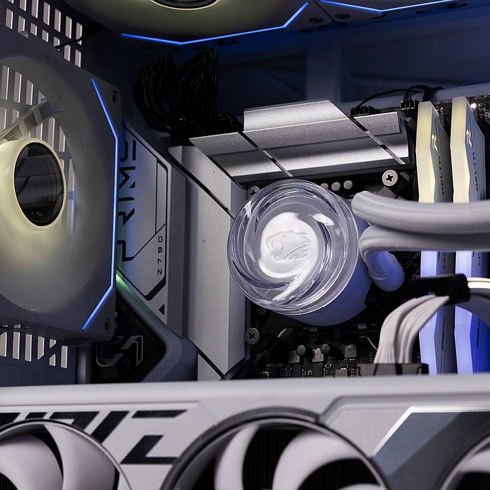 The image shows a computer tower with a clear plastic container sitting on top of it. The container appears to be a cooling system or a fan. The computer tower is surrounded by cables and wires, indicating that it is a complex system. The container is placed in the middle of the tower, and the wires are spread out around it. The overall scene suggests that the computer is well-maintained and organized, with the clear container serving as a focal point.