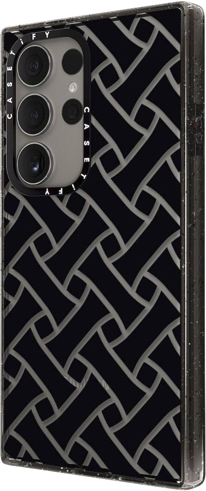 The image features a black and silver case for a cell phone. The case has a unique design with a pattern of interlocking circles. The case is made of metal, giving it a sleek and modern appearance. The cell phone is placed inside the case, which is displayed against a white background.