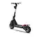 The image features a black scooter with a large seat and a black handlebar. The scooter has a black wheel and is equipped with a helmet holder. The scooter is parked on a white background, making it stand out as the main focus of the image.