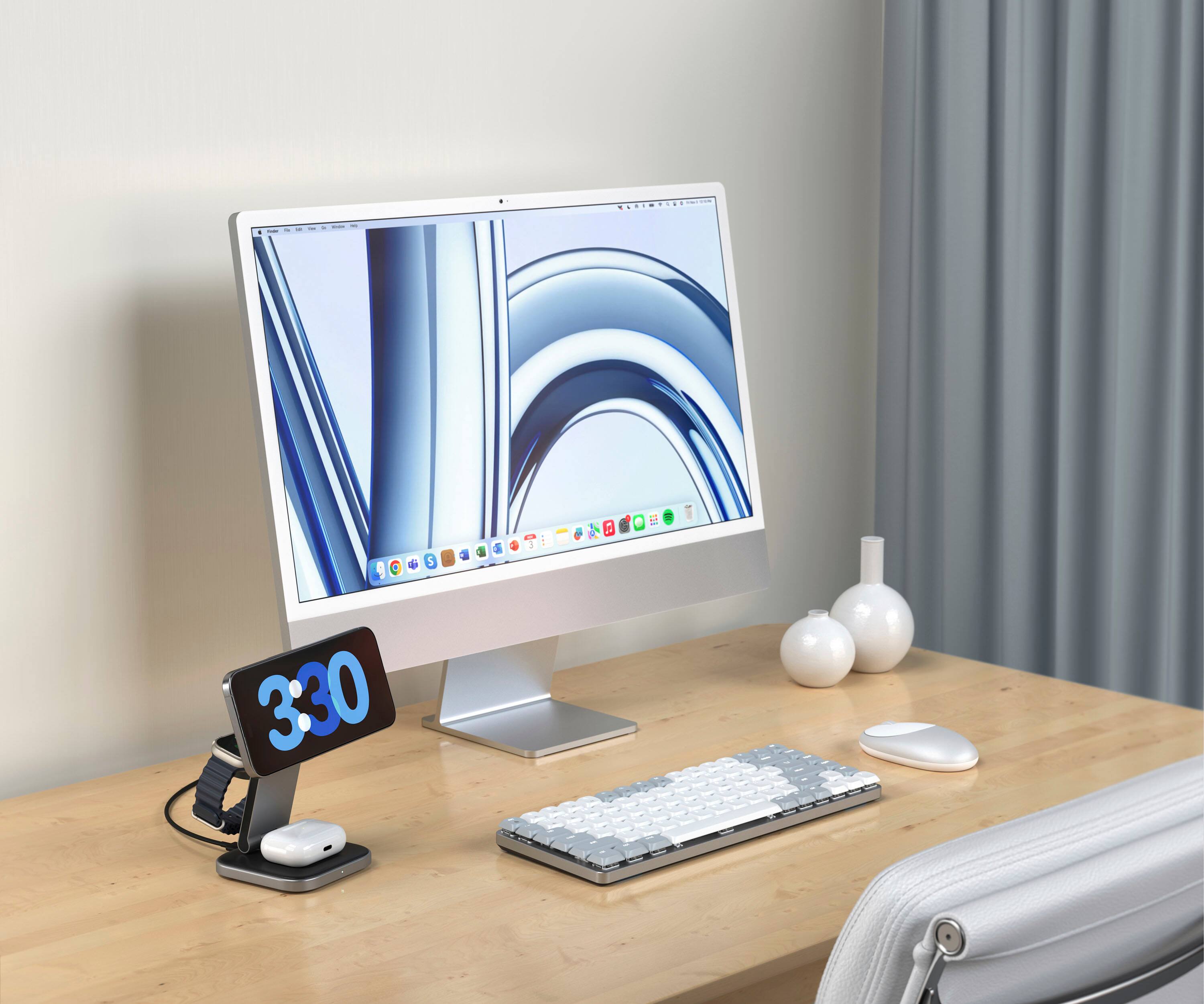 The image features a computer setup on a desk, including a keyboard, a mouse, and a monitor. The monitor displays the time as 3:30. The setup is placed on a wooden desk, and there is a chair nearby.