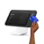 A man is holding a $65.70 Visa card in front of a cash register. The total cost of the transaction is $35.00, and the man is paying with a mix of items, including drinking glasses, mixing bowls, and other tableware. The transaction appears to be completed successfully.