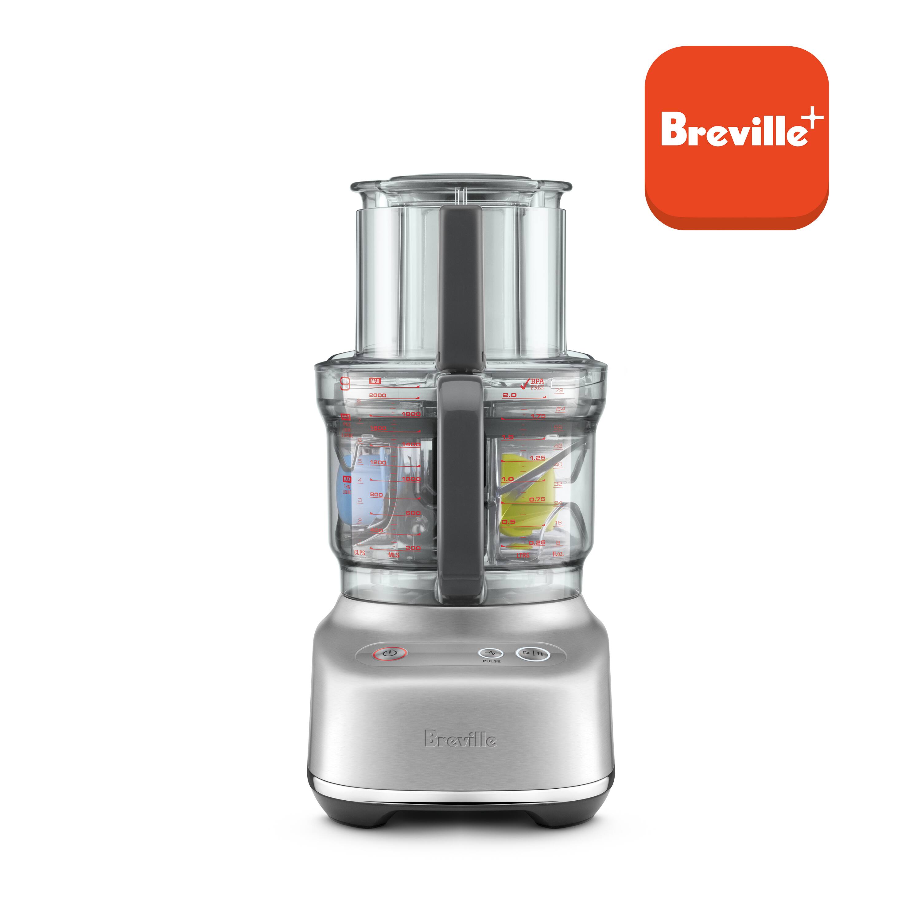 The image features a Breville blender, which is a silver and black appliance. The blender is filled with various ingredients, and it is ready to be used. The blender has a large container for blending, and it is designed to handle multiple tasks, such as chopping, mixing, and pureeing. The appliance is likely to be a versatile and convenient addition to any kitchen.