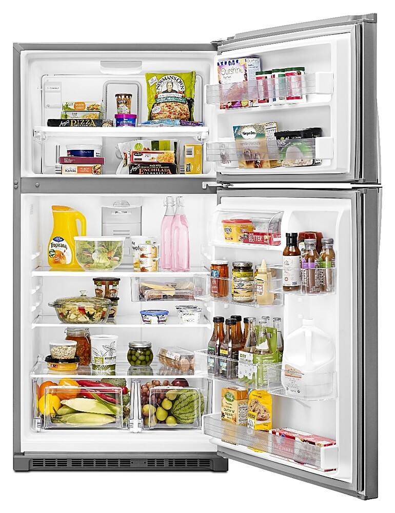 The image shows a refrigerator with its door open, revealing a variety of food items inside. The refrigerator is stocked with several bottles, including Tropicana orange juice, and other items such as milk, bananas, and a bowl of food. The refrigerator is also filled with different types of drinks, including a bottle of wine. The assortment of food and drinks in the refrigerator suggests that it is well-stocked and ready for use.