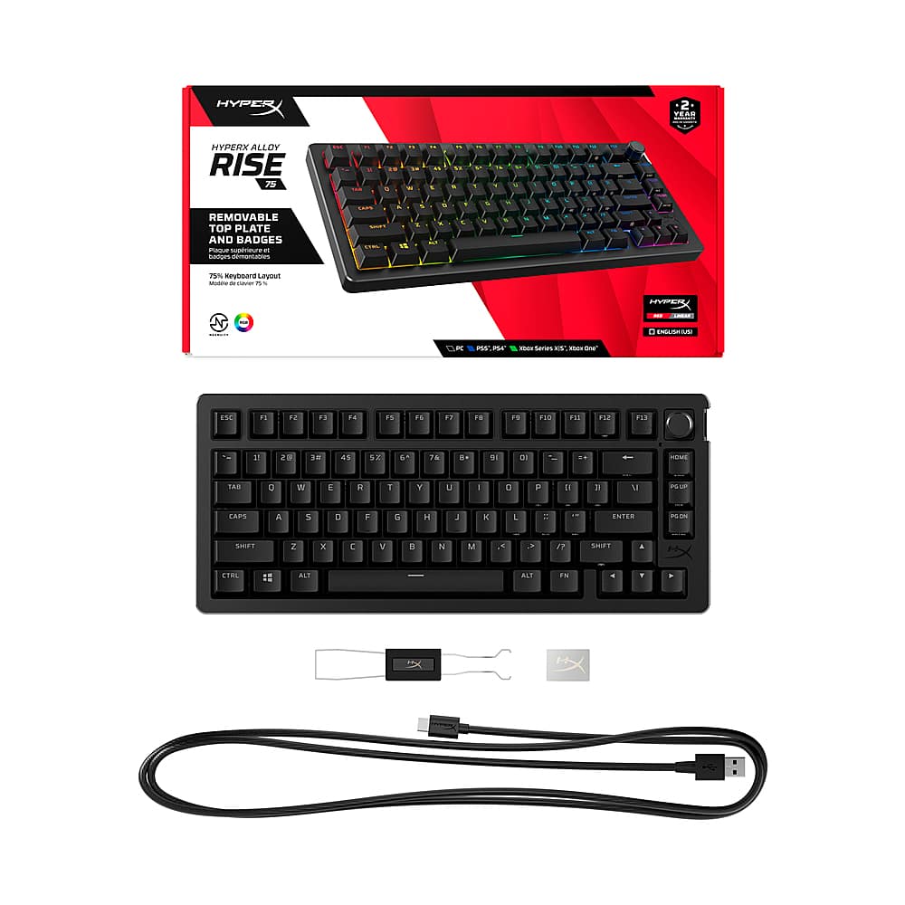The image features a HyperX Rise keyboard with a detachable top plate and badges. The keyboard is designed with a black color scheme and has a USB cable attached to it. The keyboard is displayed in a box, and it is accompanied by a set of keys. The HyperX Rise keyboard is a versatile and customizable option for gamers and users who want to personalize their gaming experience.
