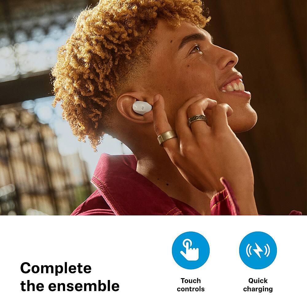 The image features a young man with curly hair, wearing a red shirt and a ring, holding a cell phone to his ear. The text "Complete the ensemble" is displayed above the man, while "Touch controls" and "Quick charging" are placed below him. The man appears to be smiling, suggesting that he is enjoying the conversation or the experience of using the cell phone.