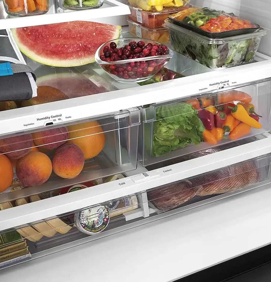 The image shows a refrigerator filled with various food items, including fruits, vegetables, and meat. The refrigerator is stocked with a wide variety of items, such as carrots, apples, oranges, and broccoli. The fruits are placed in the top section of the refrigerator, while the vegetables are stored in the middle and bottom sections. The meat is located in the lower part of the refrigerator. The refrigerator is well-organized, making it easy to find and access the desired items.