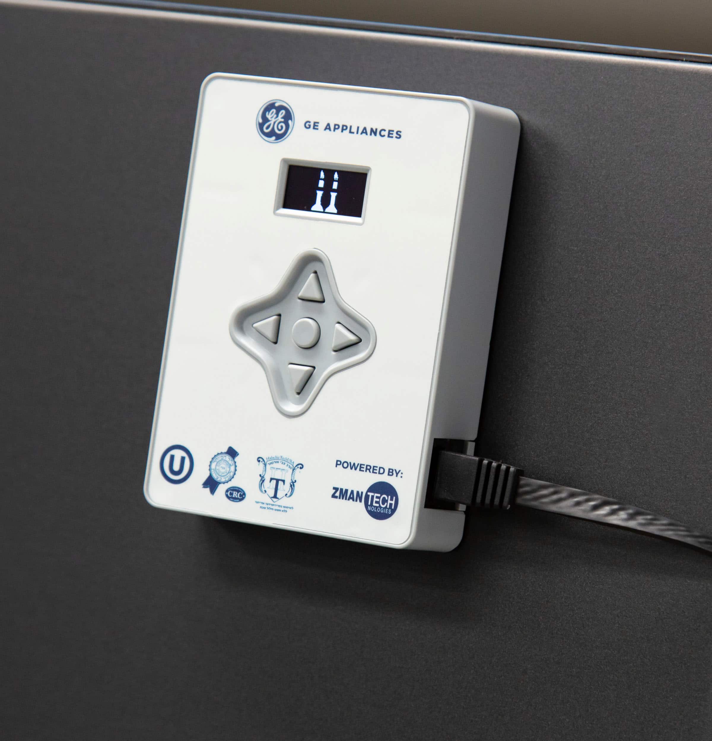 The image features a white device with a digital display, which is powered by Zman Tech. The device is attached to a black surface, possibly a wall or a countertop. The display shows the number 11, which could be a temperature or a timer setting. The device is likely used for monitoring or controlling a specific function, such as temperature or time, in a household or industrial setting.