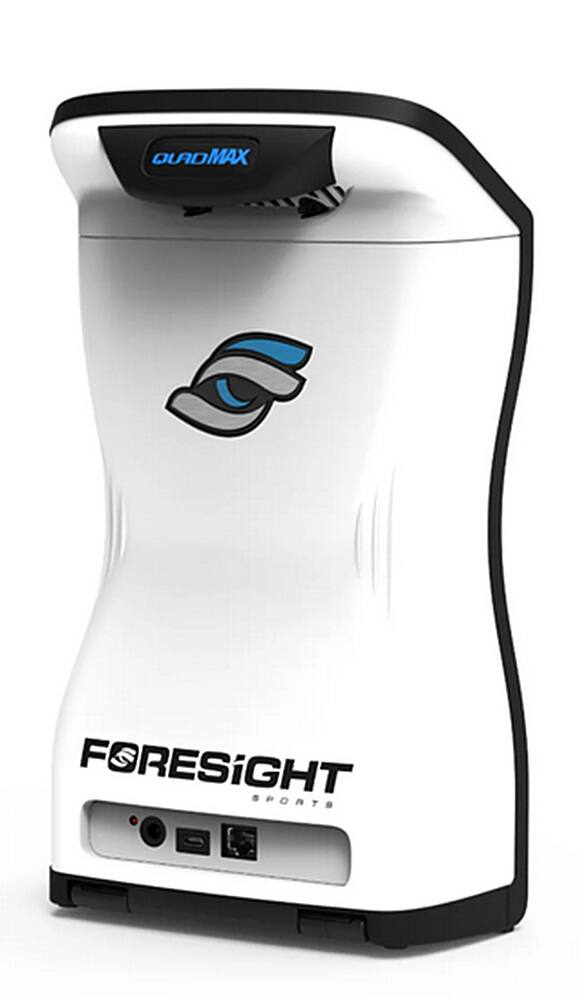 The image features a white and black electronic device, likely a sports machine, with the word "Foresight" written on it. The device is placed on a white background, making it stand out prominently. The focus of the image is on the "Foresight" logo, which is the largest text in the scene.
