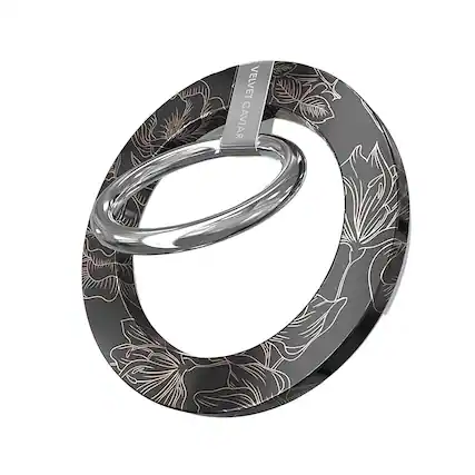The image features a ring with a floral design on it. The ring is made of metal and has a circular shape. The design includes a combination of leaves and flowers, giving it an elegant and artistic appearance. The ring is displayed in a close-up view, showcasing its intricate details and craftsmanship.