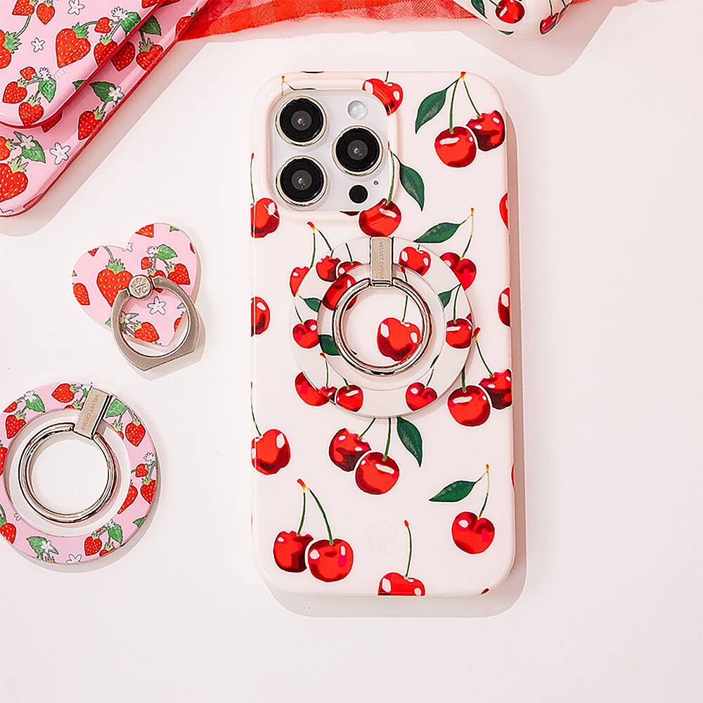 The image features a pink and white case for a cell phone, which has a cherry design on it. The case is placed on a white surface, and there are two other cherry-themed items nearby. The case is the main focus of the image, and it is likely that the cherry theme is a popular design choice for these items.