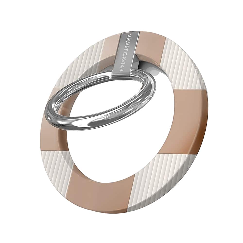 The image features a close-up of a ring with a brown and white striped band. The ring is made of metal and has a silver appearance. The ring is designed with a unique combination of brown and white colors, making it stand out. The ring is placed on a white background, which further highlights its distinctive design.