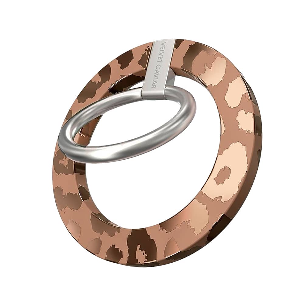 The image shows a close-up of a ring with a leopard print design. The ring is made of metal and features a silver tone. The ring is circular in shape and has a unique pattern on it. The ring is displayed on a white background, which emphasizes the intricate details of the design.