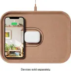 The image shows a white iPhone charger plugged into a wall outlet. The charger is connected to a brown case that has a picture of the iPhone on it. The case is placed on a table, and the iPhone is sitting on top of the case. The charger is fully charged, as indicated by the image.