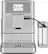 The image features a silver KitchenAid coffee maker with a glass carafe and a cup. The coffee maker is turned on and ready to brew a cup of coffee. The coffee maker is placed on a countertop, and the glass carafe is located next to it. The cup is also placed nearby, ready for use.