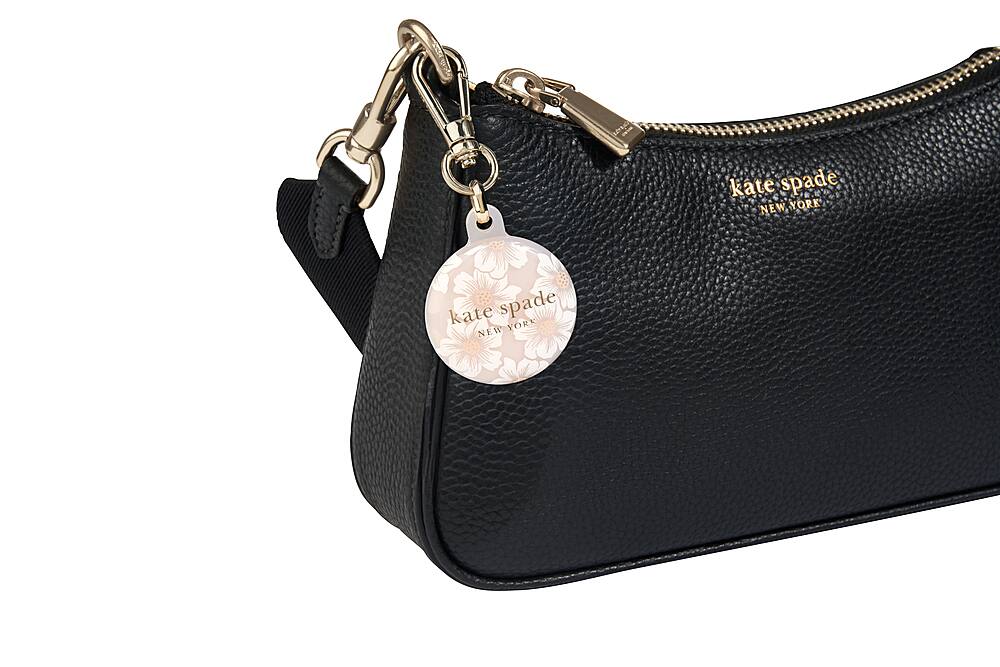 The image features a black Kate Spade New York purse with a gold chain and a heart-shaped charm. The purse is on display, showcasing its design and functionality. The Kate Spade brand is known for its stylish and high-quality handbags, and this particular purse is no exception.
