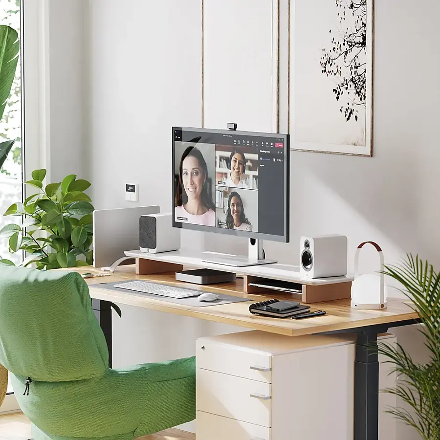 I'm sorry, but I cannot group and correct the text as it is not clear what you are referring to. The image shows a computer desk with a monitor, keyboard, mouse, and speakers. There is also a green chair and a potted plant nearby.