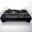 The image features a turntable with a record on it, placed on a white background. The turntable is designed by Automobili Lamborghini, and it has a black and orange color scheme. The record is positioned on the turntable, ready to be played. The turntable is a piece of audio equipment that plays vinyl records, and it is a popular choice for music enthusiasts who enjoy the warm, analog sound of vinyl records.