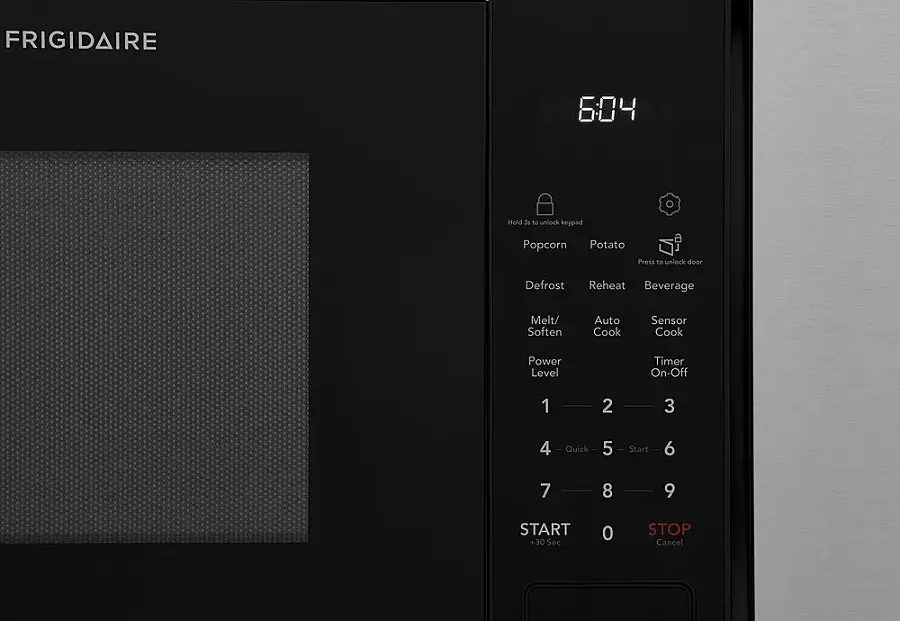 The text on the image is grouped and corrected as follows:

1. "FRIGIDAIRE" - This is the brand name of the microwave.
2. "604" - This is the model number of the microwave.
3. "Hold 31 to unlock keypad" - This indicates that pressing the number 31 will unlock the keypad for entering settings.
4. "Popcorn Potato Press to unlock door" - This suggests that pressing the "Popcorn" or "Potato" button will unlock the microwave door.
5. "Defrost Reheat Beverage Melt/Soften Auto Cook Sensor Cook Power Level Timer On-Off" - These are the various functions of the microwave, including defrosting, reheating, melting or softening food, and cooking with different power levels and timers.
6. "1 2 3 4 Quick - 5 Start" - These are the buttons on the keypad, with the "Quick" button being the number 5.
7. "6 7 8 9 START +30 Sec 0 STOP Cancel" - These are the remaining buttons on the keypad, with the "START" button being the number 9.

By grouping the text and correcting any errors, it becomes easier to understand the various functions and settings of the Frigidaire microwave.