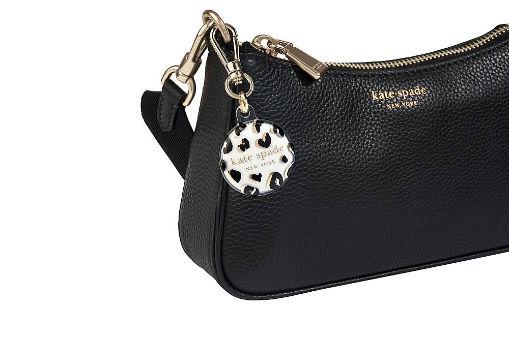 The image features a black Kate Spade New York handbag with a gold lock and key. The bag is closed and appears to be in good condition. The bag is likely used for carrying personal items and is a popular choice among fashion-conscious individuals.