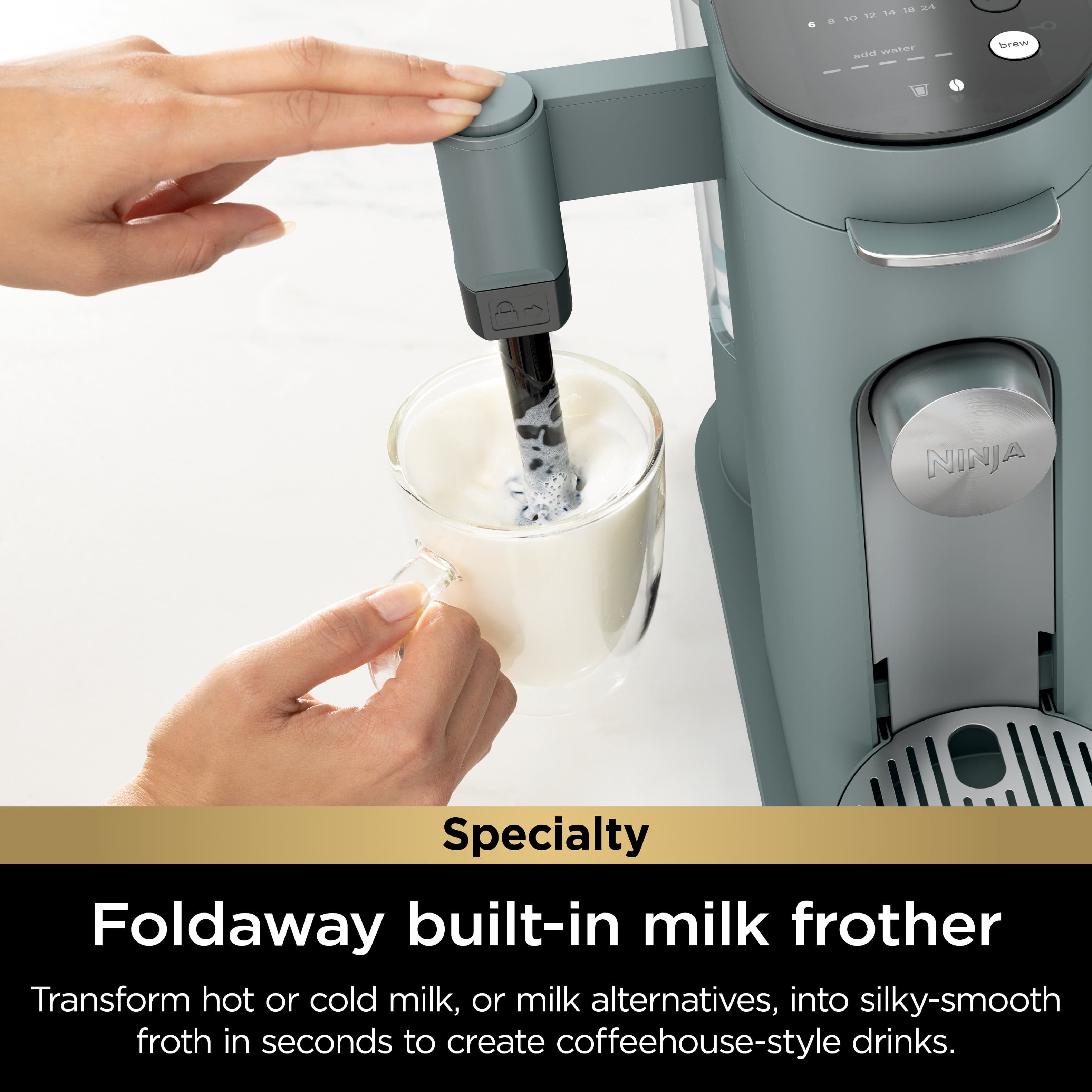 The image features a person pouring milk into a glass using a Ninja Specialty Foldaway built-in milk frother. This appliance is designed to transform hot or cold milk, or milk alternatives, into silky-smooth froth in seconds, allowing users to create coffeehouse-style drinks at home. The Ninja Specialty Foldaway built-in milk frother is a convenient and efficient way to prepare delicious milk-based beverages.