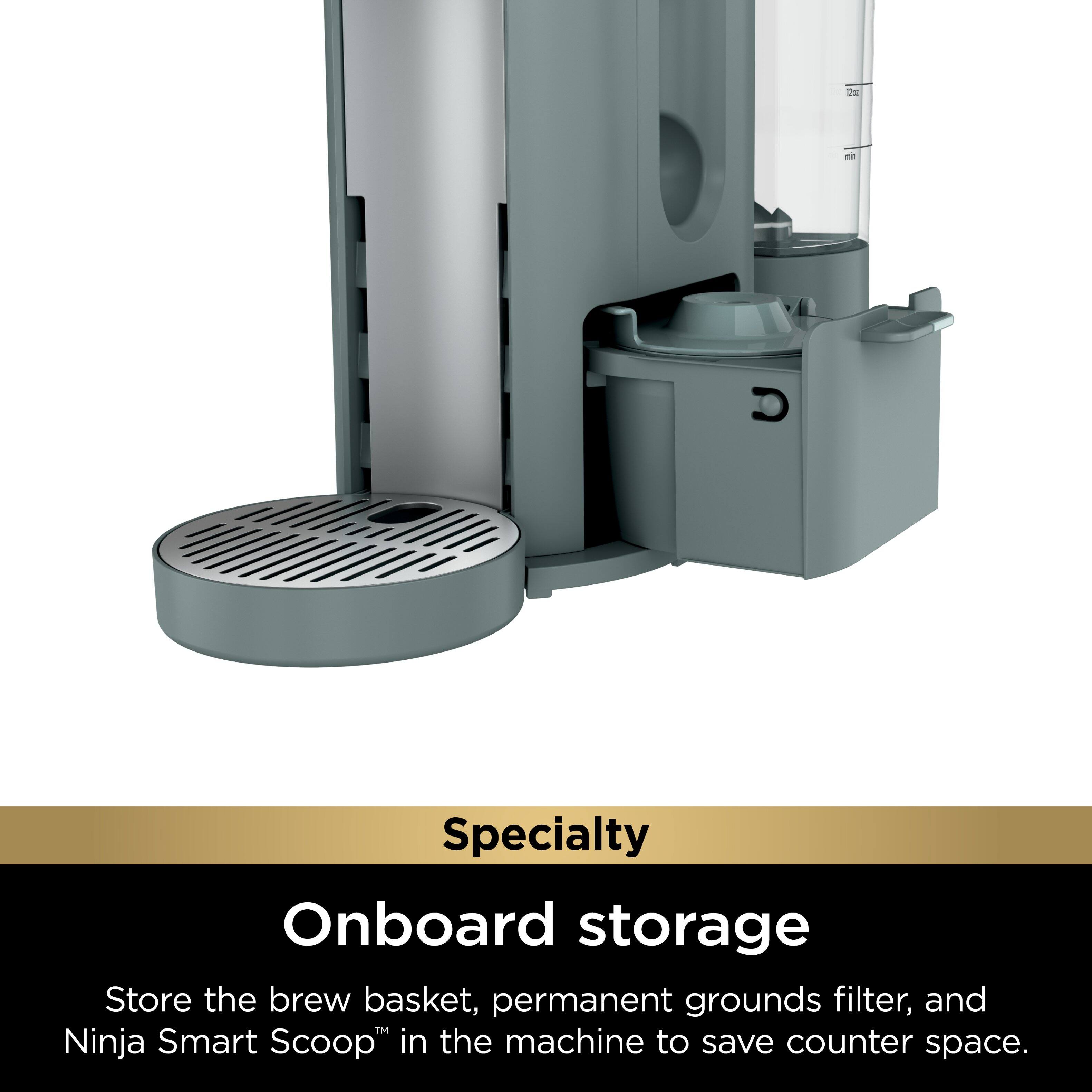 The image features a specialty coffee maker with a unique design. It has a large container that serves as a storage area for various coffee-making accessories. The container is located on the side of the coffee maker and is designed to save counter space. The coffee maker also has a built-in brew basket, a permanent grounds filter, and a Ninja Smart Scoop, which can be stored within the machine. This innovative design makes it a convenient and space-saving option for coffee enthusiasts.