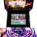 The image features a video game machine with a purple and black color scheme, showcasing a game called "Teenage Mutant Ninja Turtles in Time." The game is displayed on a screen, and a person's hand is visible near the bottom of the image, likely interacting with the game controls. The machine is designed to accept coins, and the game is likely a popular choice among players.