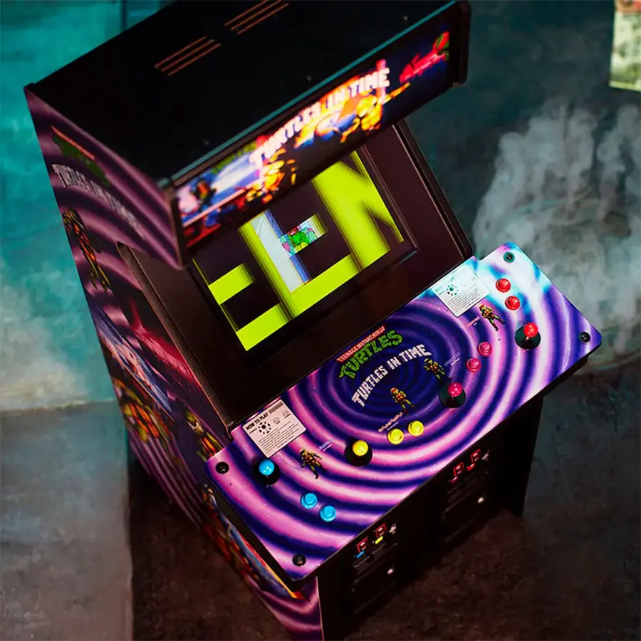 The image features a colorful video game machine with a purple and black design. The machine is displaying the game "Turtles in Time," which is an arcade game. The game is set in a futuristic time period, and the machine is filled with buttons and a screen. The machine is likely a part of a larger arcade setup, offering a fun and engaging gaming experience for players.